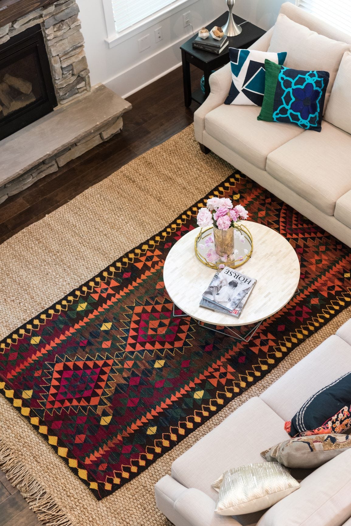 layering tribal rug on jute rug