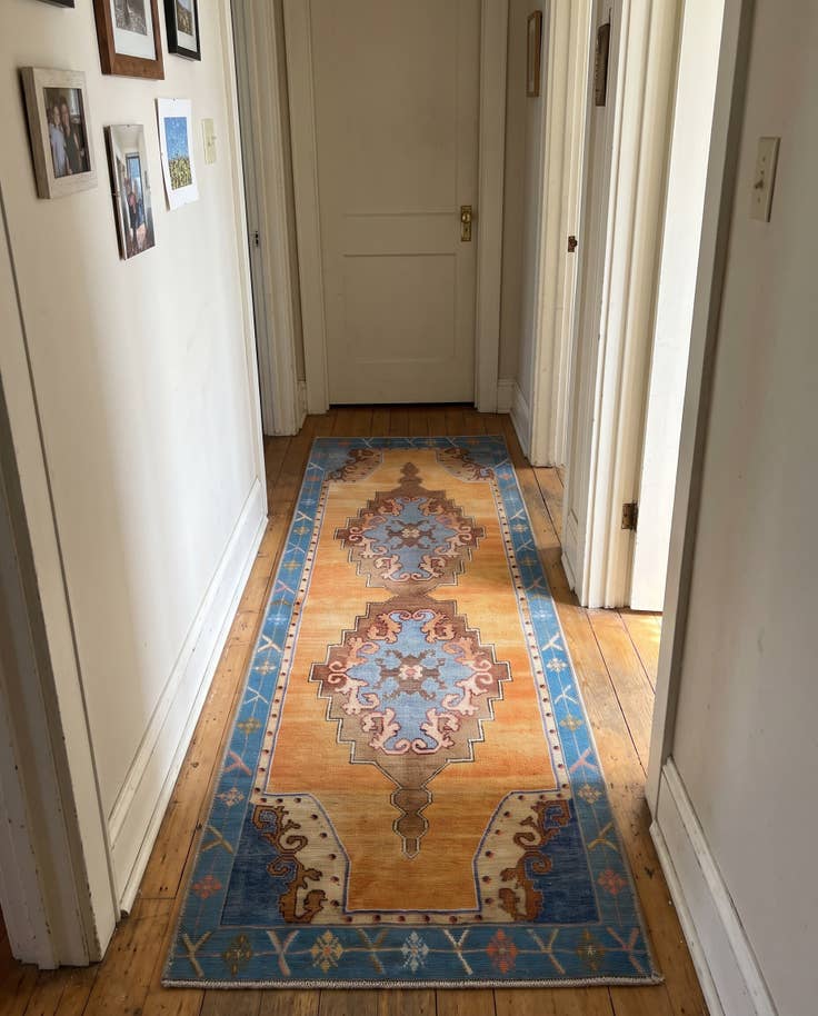 Detail image of 2' x 6' Sanderson · Medallion Washable Rug, orange and blue
