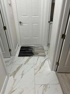 Customer photo for review titled "Cowhide Rug at Hall Entry"