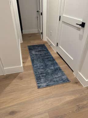 Customer photo for review titled "The 2x6 Asha runner is perfect in our new home"