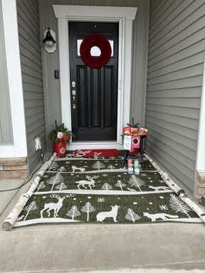 Customer photo for review titled "Santa loves my new rug"