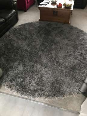 Customer photo for review titled "8’ Round Silver Dark Grey rug"