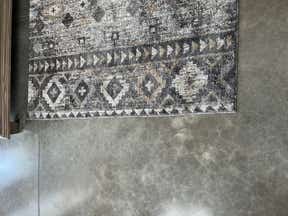 Customer photo for review titled "Love this rug. But…"