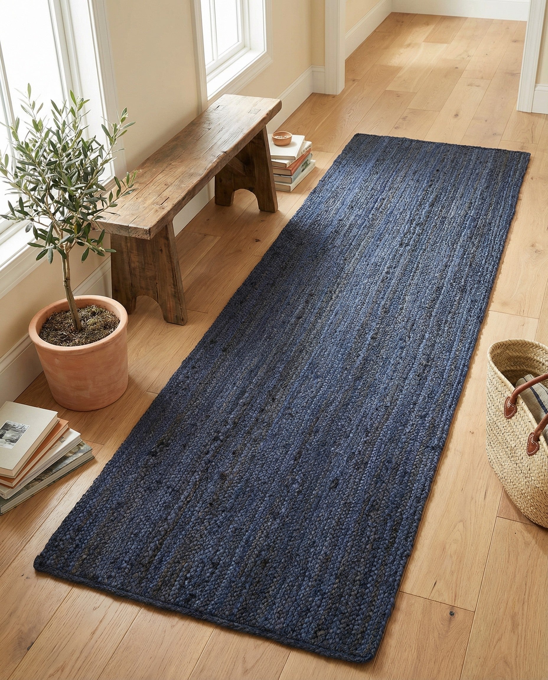 A 6 ft navy blue braided jute runner rug with a textured flatweave, ideal for a hallway.
