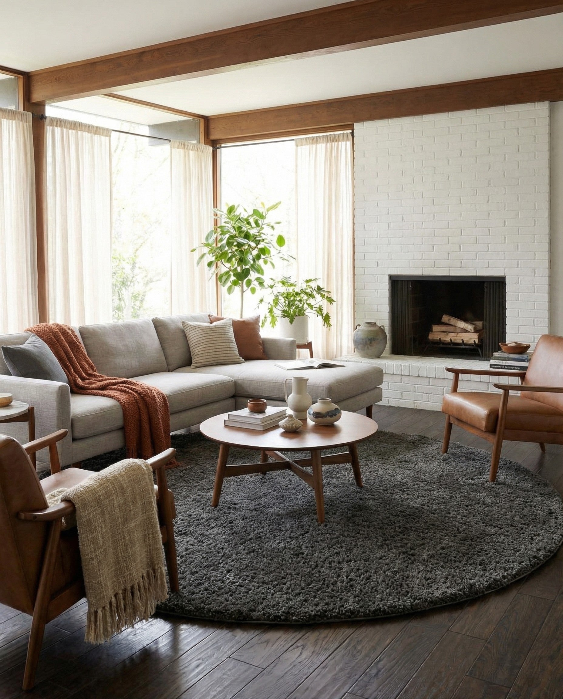 A large 10' 2 x 10' 2 round gray shag rug with a plush, textured pile, suitable for modern indoor spaces.