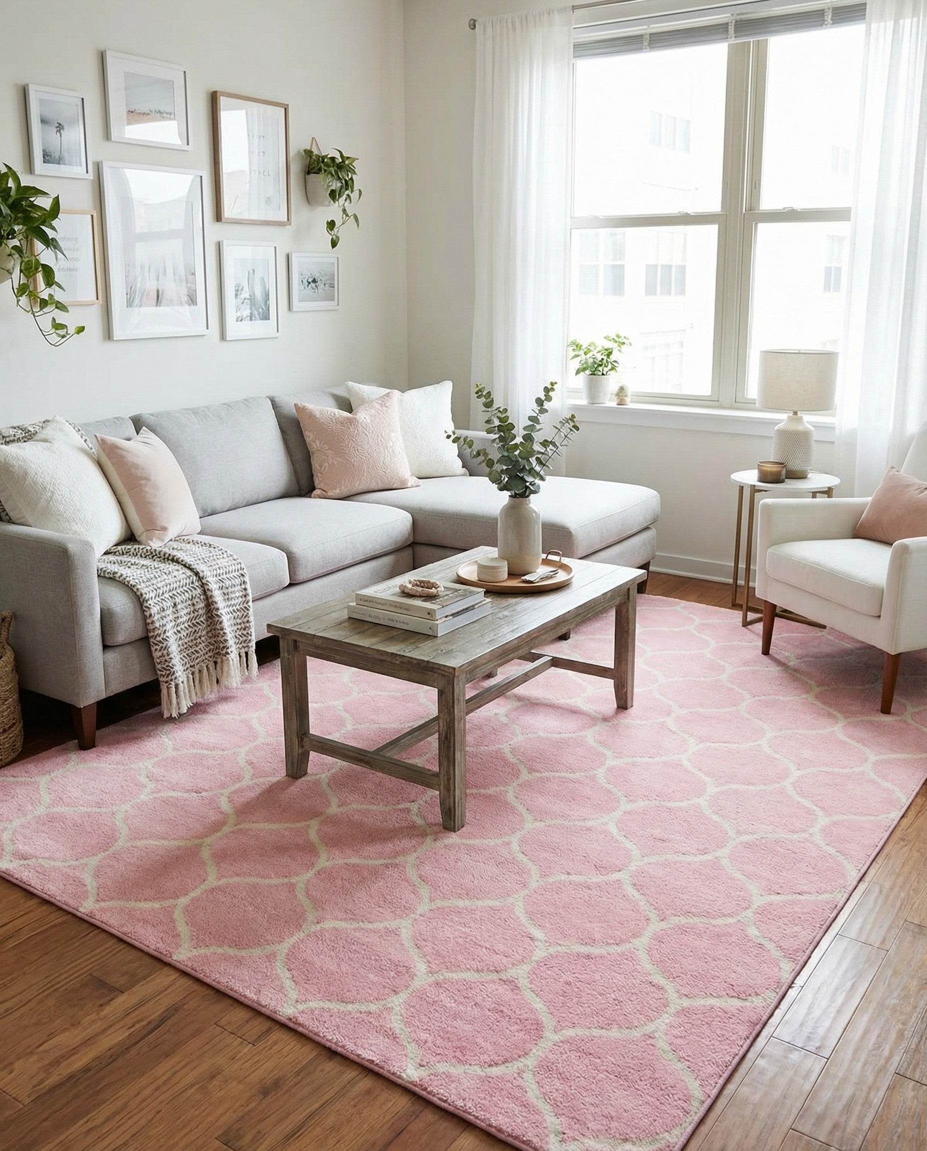 A 10x14 rectangular pink area rug with a repeating off-white modern trellis pattern, suitable for an indoor living space.