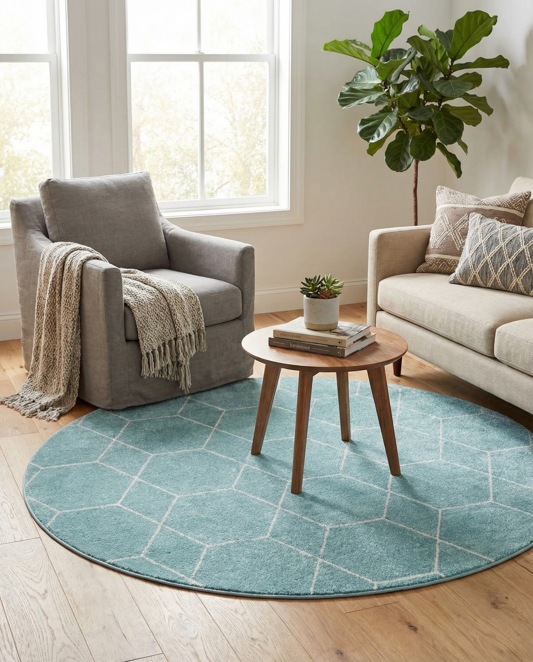 A 4' round light blue rug with a white modern geometric trellis pattern, suitable for indoor spaces.