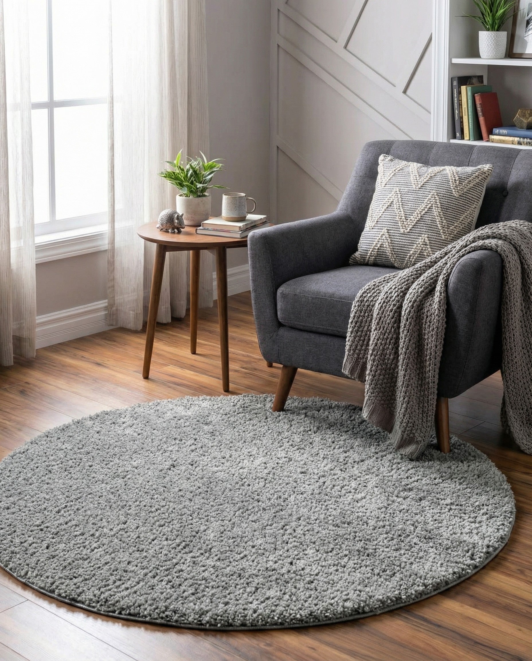 A 5' 0 x 5' 0 round gray shag rug with a textured, plush pile, ideal for modern indoor spaces.