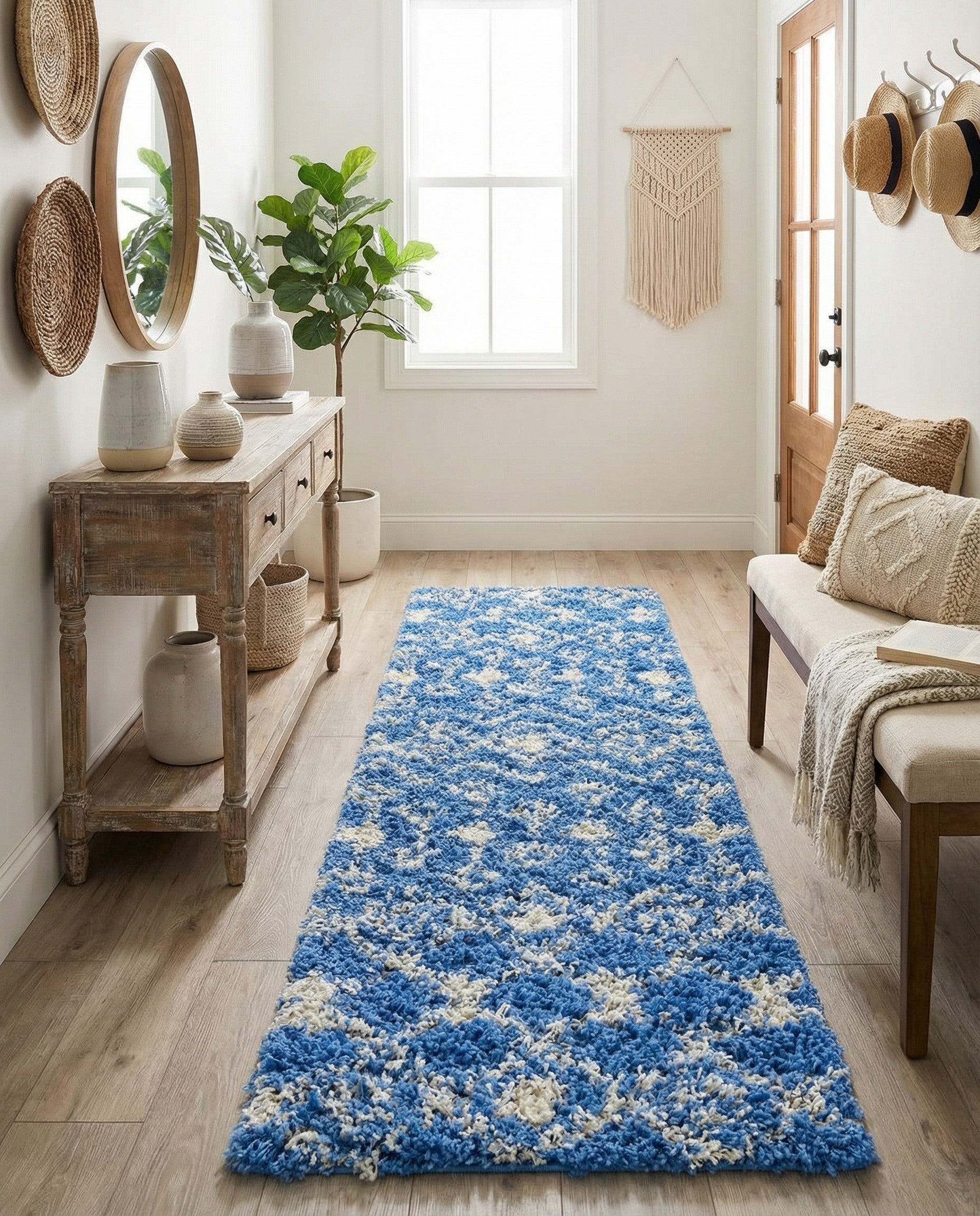 A long 10 ft runner rug featuring a plush blue shag pile with a white tribal geometric pattern.