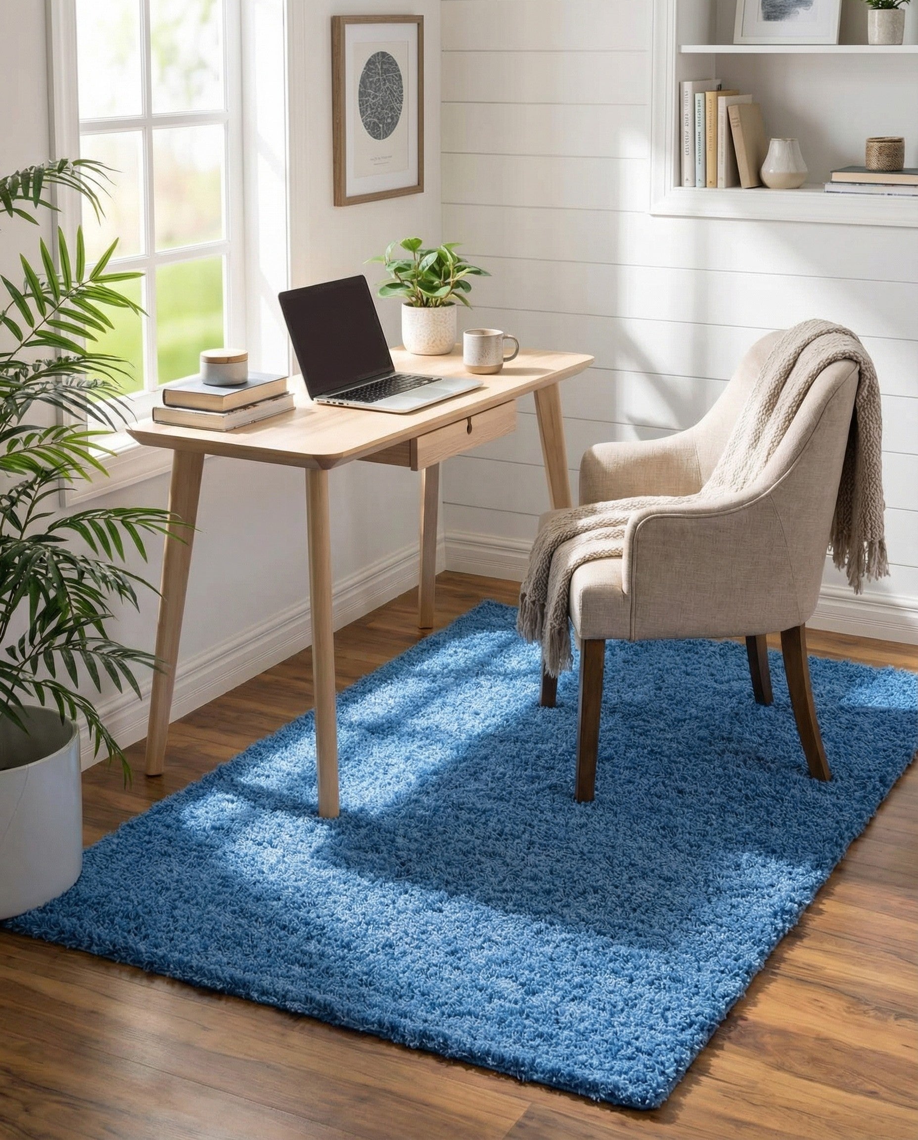 A vibrant blue 2x3 rectangular shag rug, showcasing its plush, textured pile suitable for a modern indoor space.