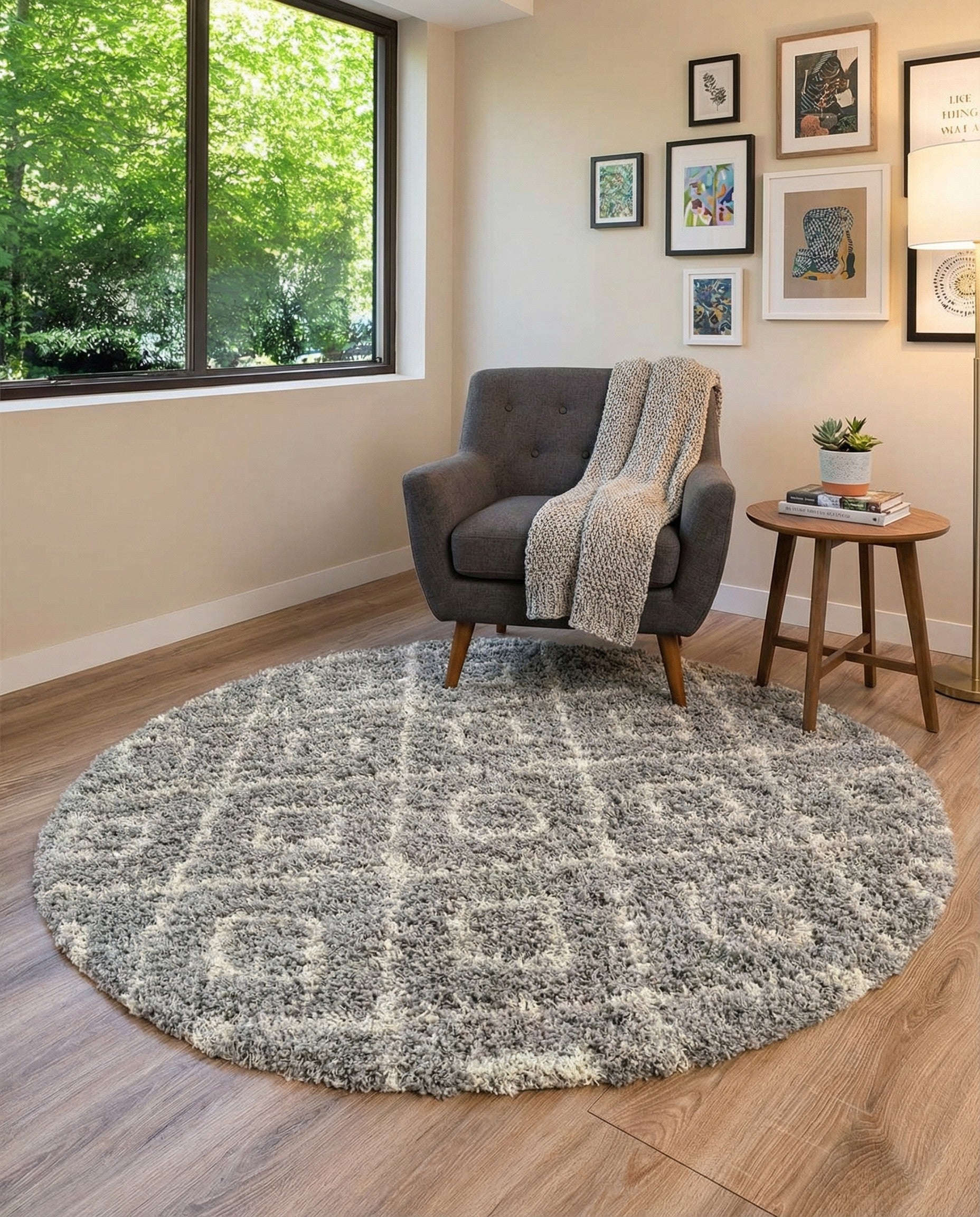 A round, high/low pile gray and white shag rug with a modern trellis pattern, suitable for indoor spaces.