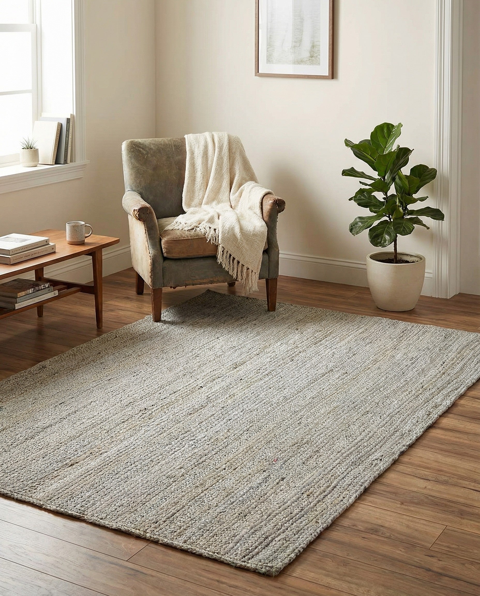 A 4x6 rectangular gray braided jute rug with a textured, minimalist flatweave design, perfect for a living room.