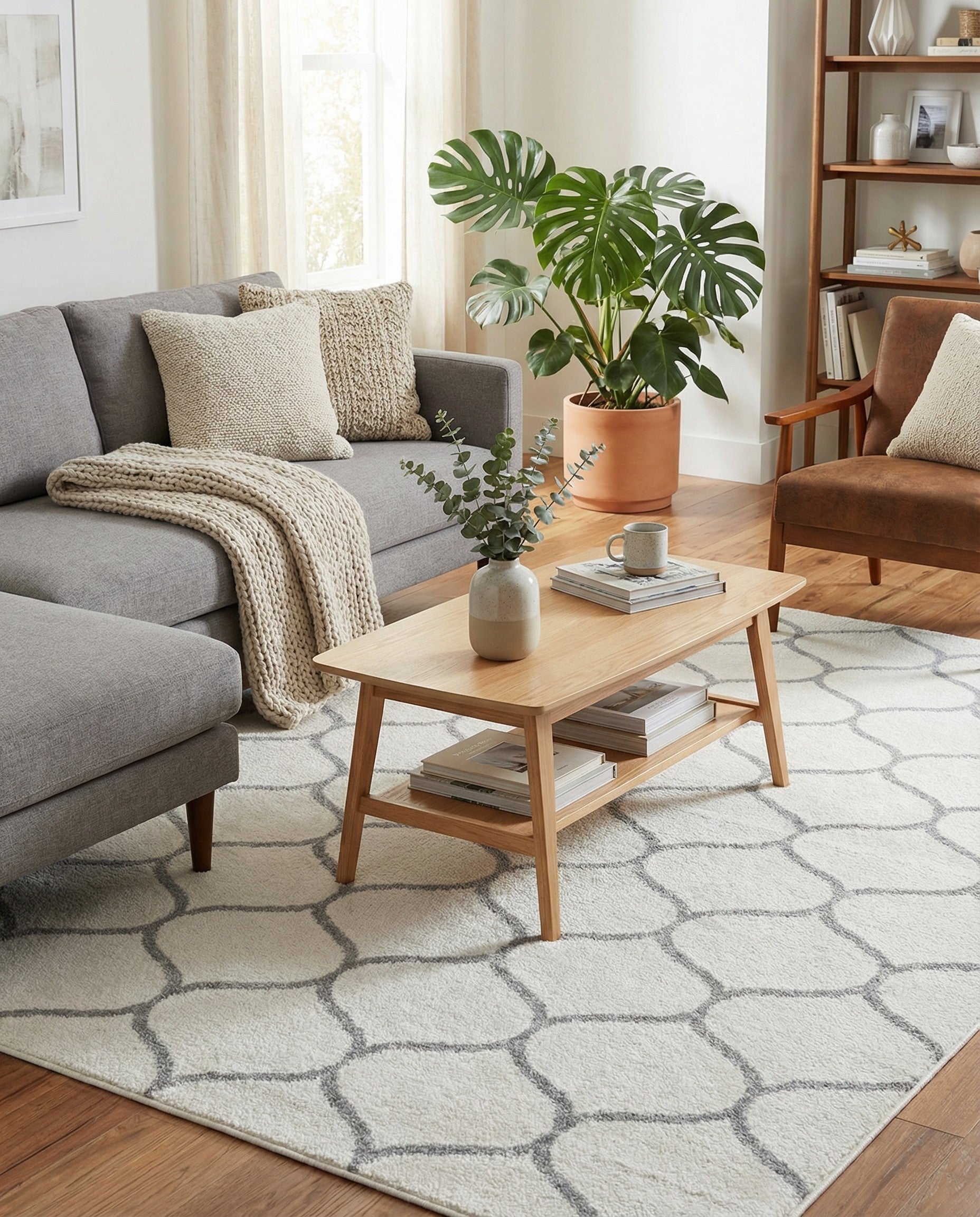 A rectangular 7x10 ivory area rug with a modern gray trellis pattern, suitable for a living room.