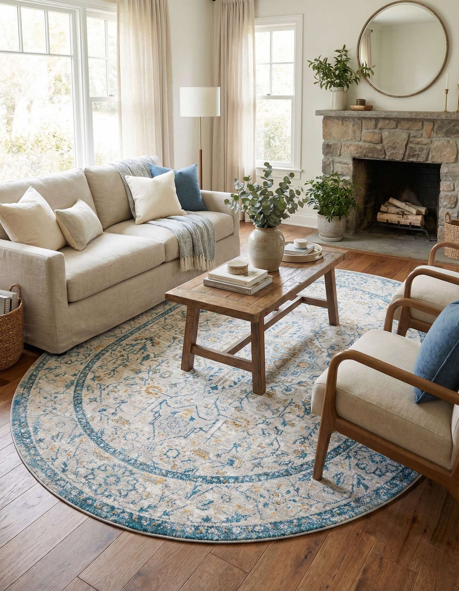 An oval 7' 10 x 10' 2 Lola Collection rug with a distressed gray, blue, and gold medallion and floral pattern.