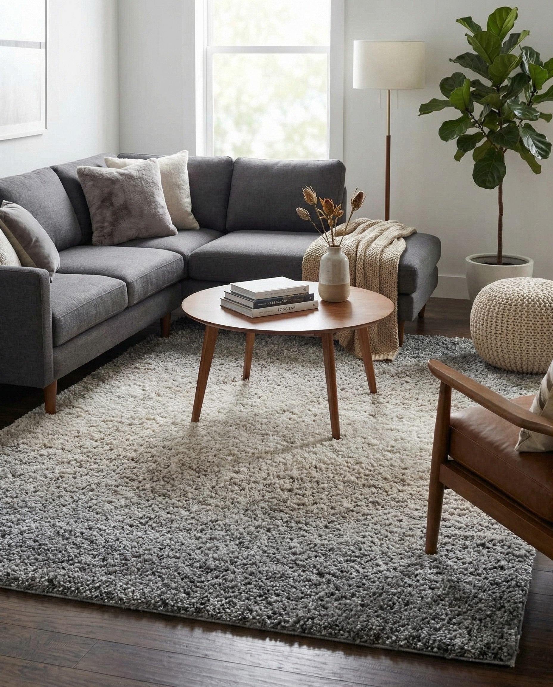 A rectangular 9x12 Athena Shag rug featuring a modern gray and silver ombre design with white tassels.