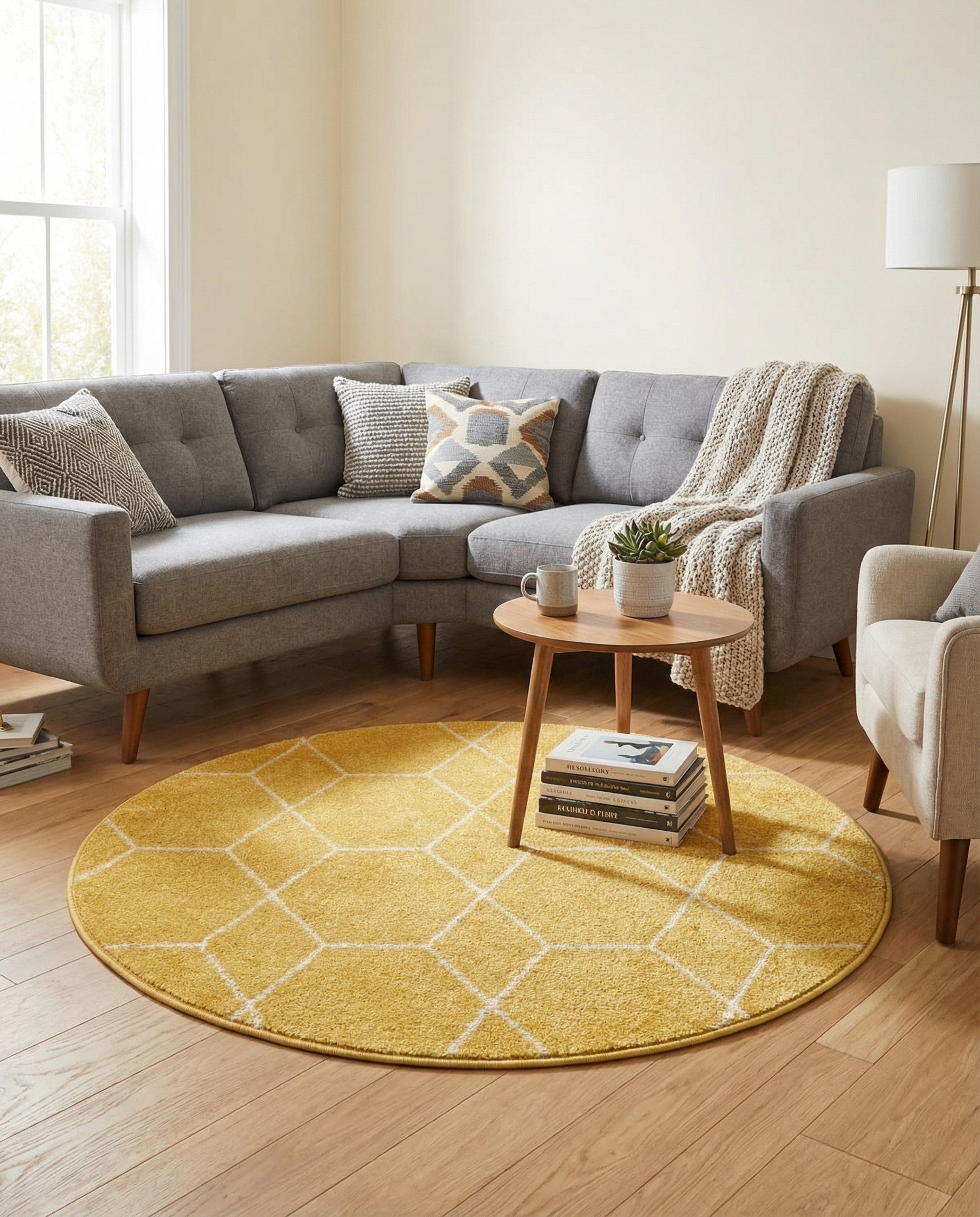 A 4' round yellow rug with a modern white geometric trellis pattern, made of polypropylene.