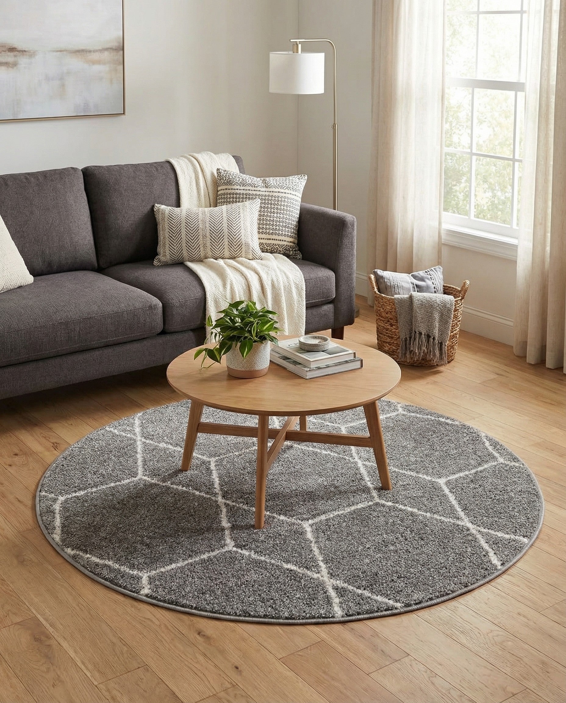 A 3' round gray modern rug with a white geometric trellis pattern, made from polypropylene.