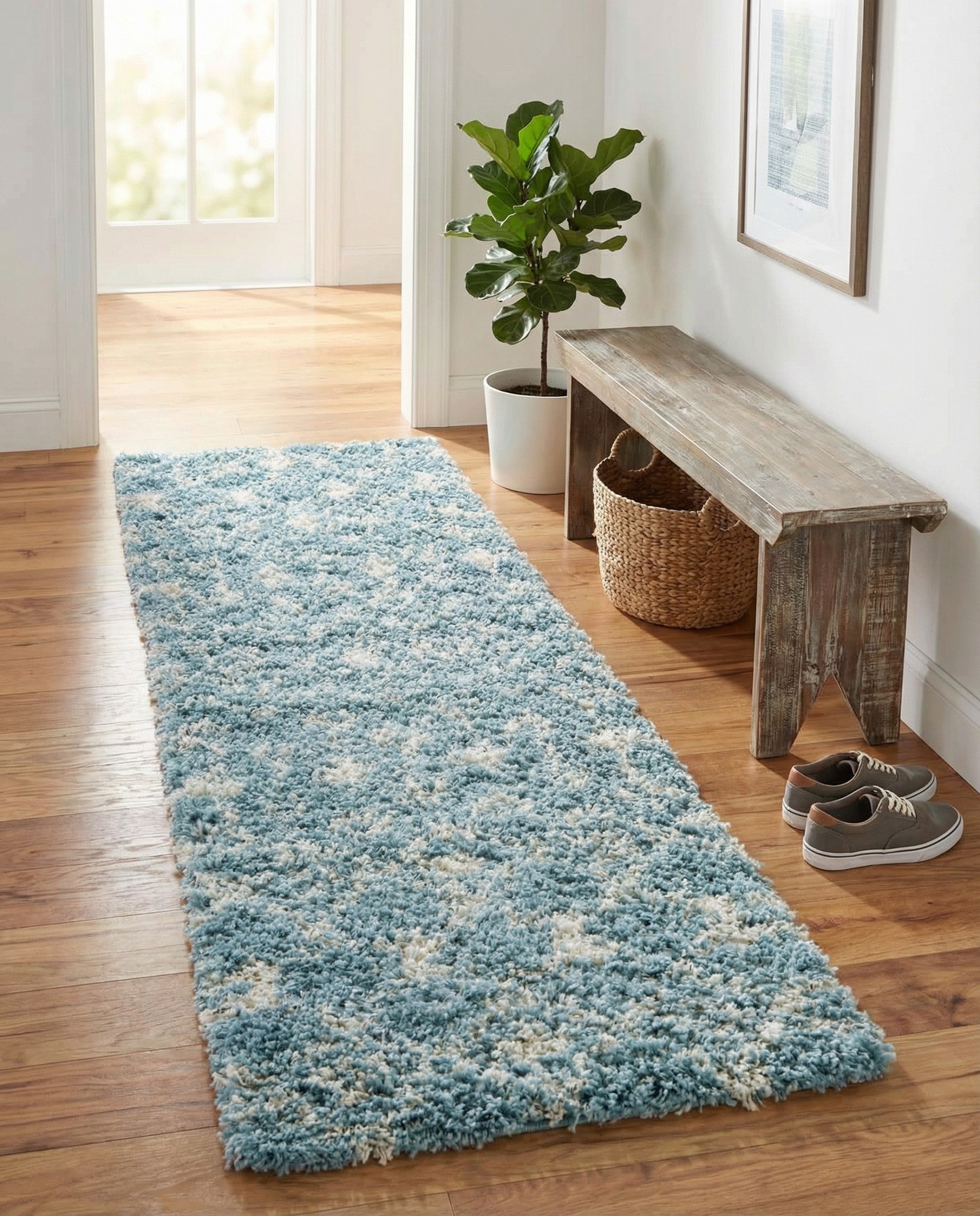 A long, plush 12 ft runner rug in light blue with an off-white tribal geometric pattern, suitable for a hallway.