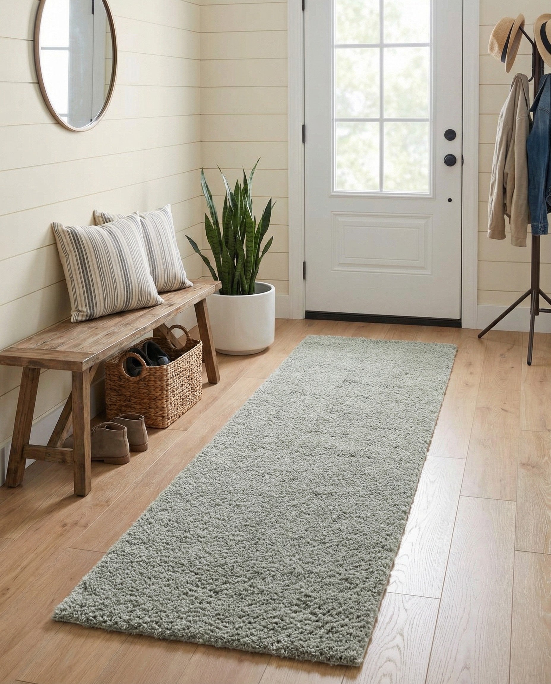 A soft, plush 7 ft runner rug in a solid sage green color, perfect for adding comfort to a hallway.