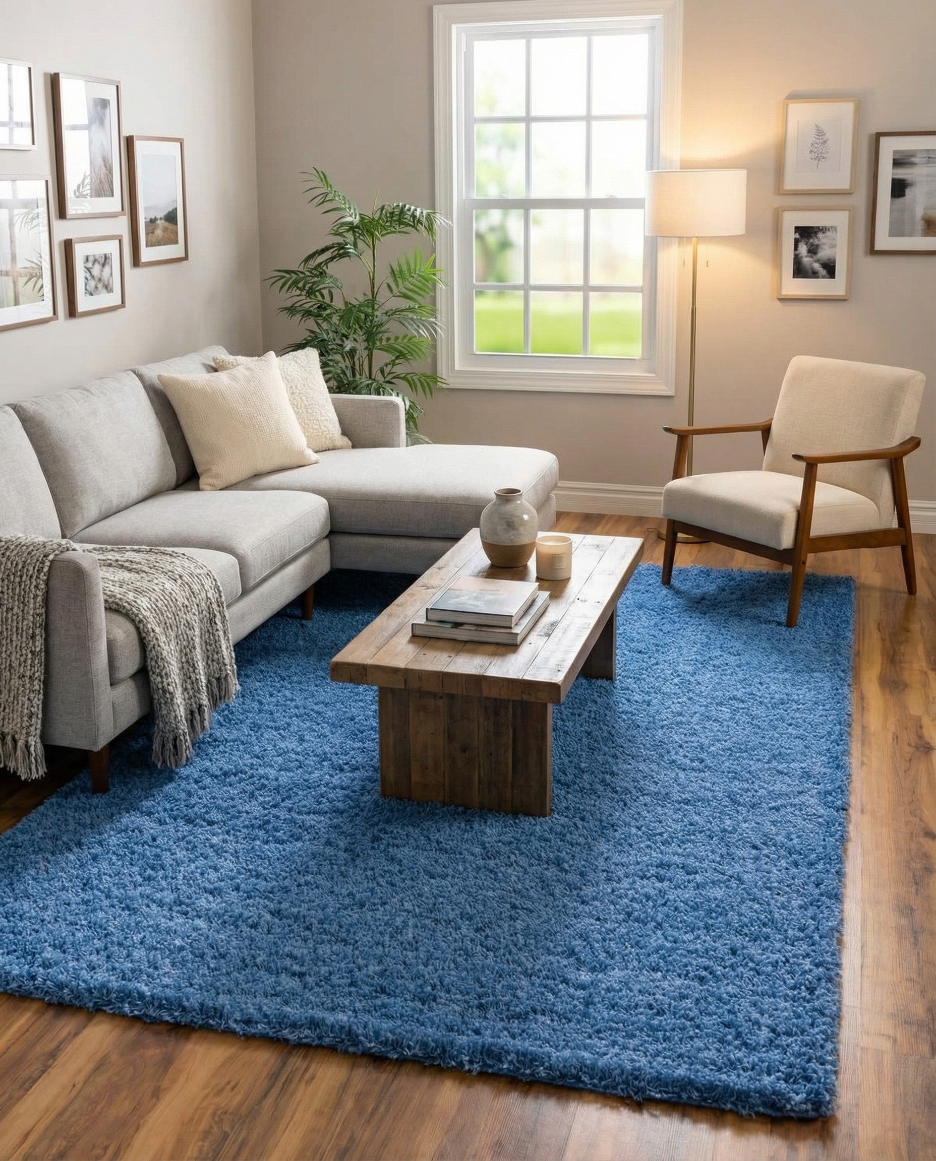 A large 10x13 rectangular blue shag rug with a plush, textured pile, perfect for a modern living room or bedroom.