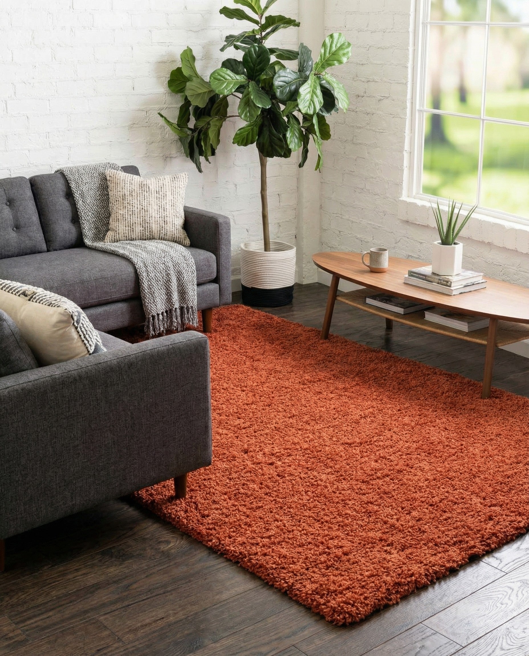 A rectangular 5x8 orange shag rug with a textured, plush pile, suitable for a living room or bedroom.