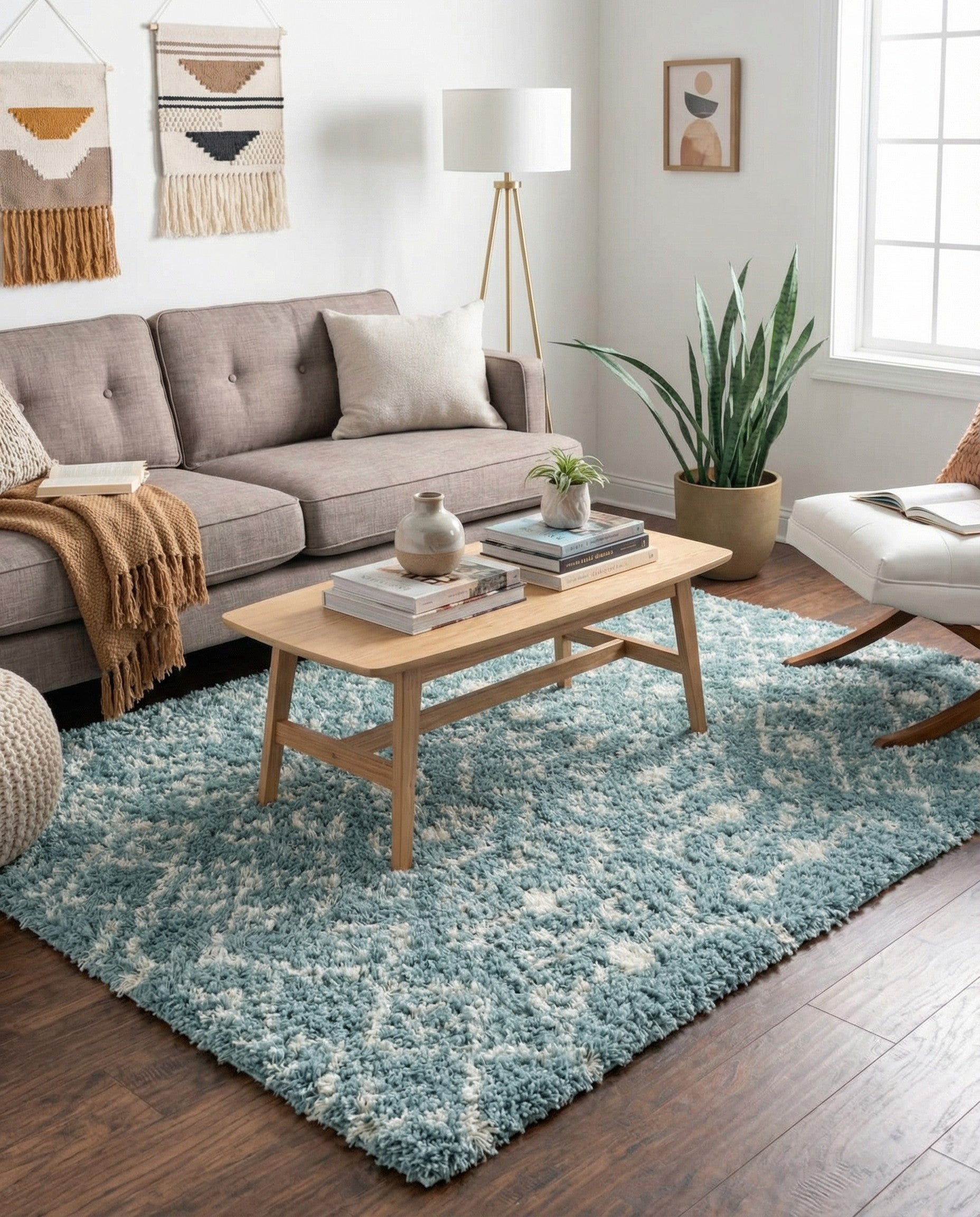 A rectangular 8x10 light blue shag rug with a cream tribal geometric pattern, perfect for a living room.