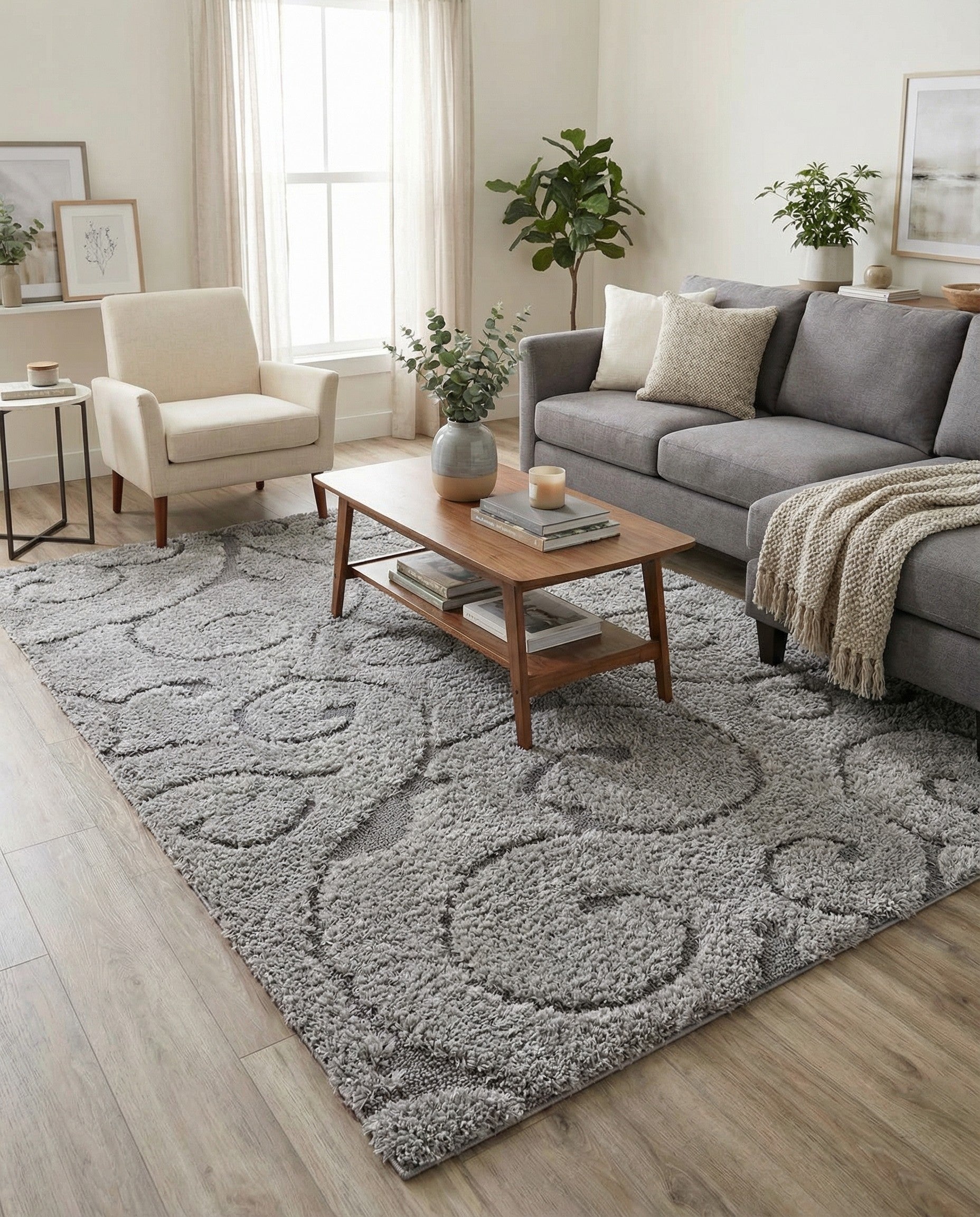 A 9x12 rectangular light gray rug with a textured gray transitional scroll pattern, ideal for a living room.