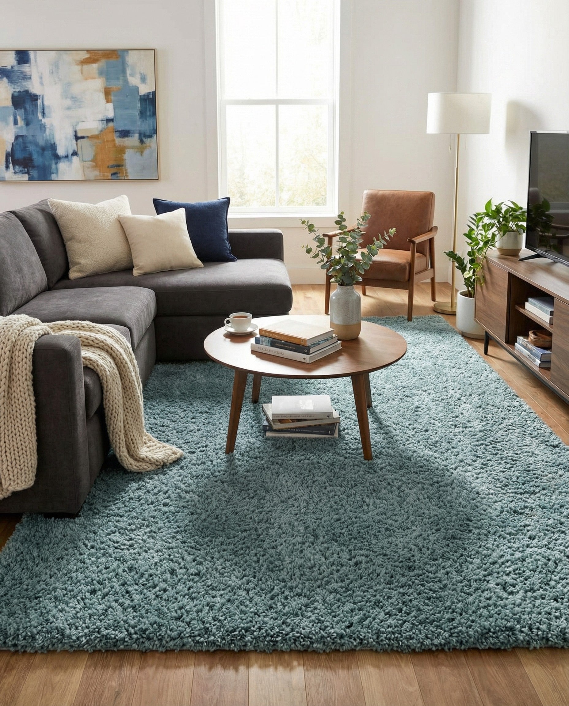 A rectangular 10x13 blue shag area rug with a plush, textured pile, perfect for a modern living room.