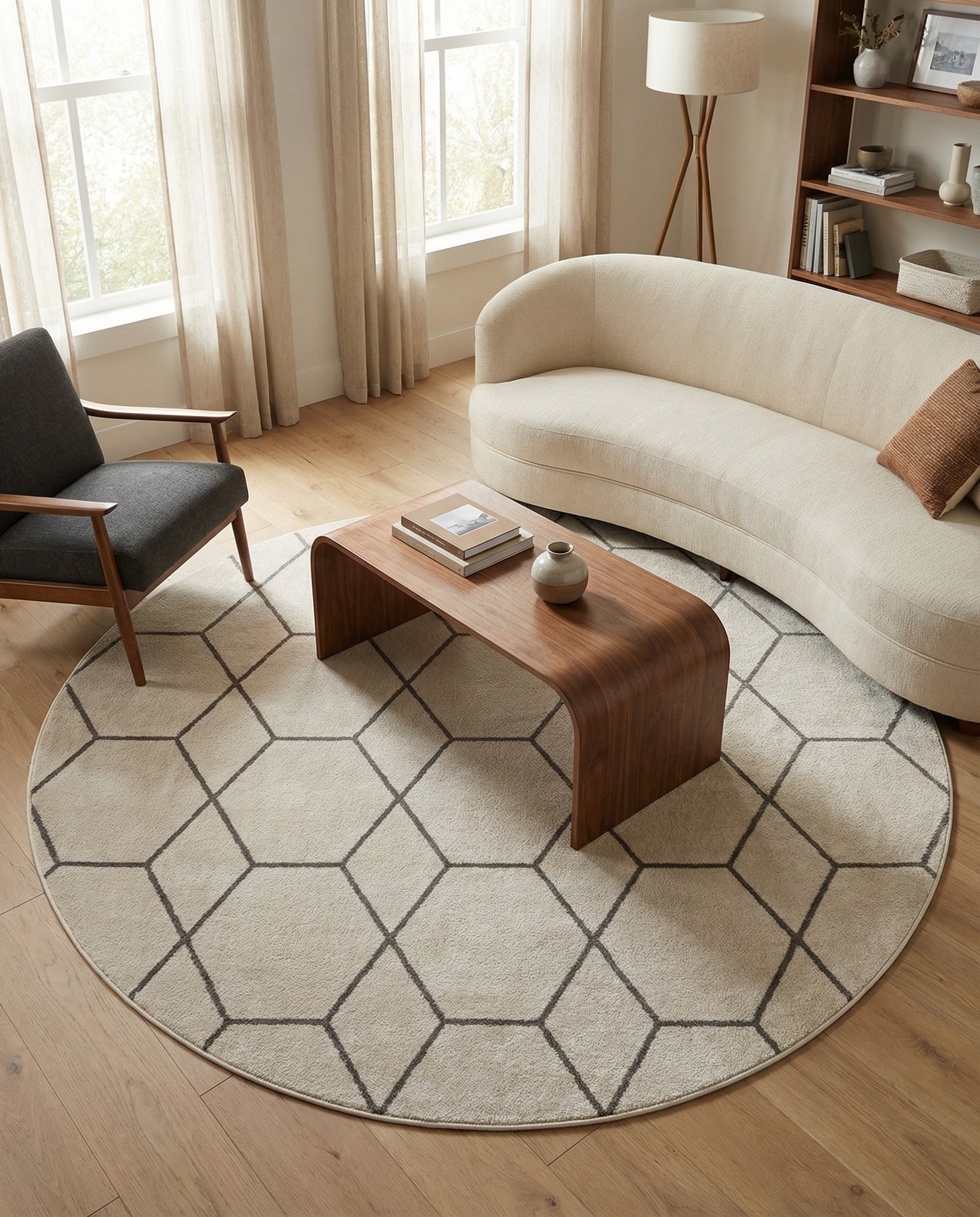 A round ivory and cream rug with a modern dark gray geometric trellis pattern, ideal for a contemporary living space.