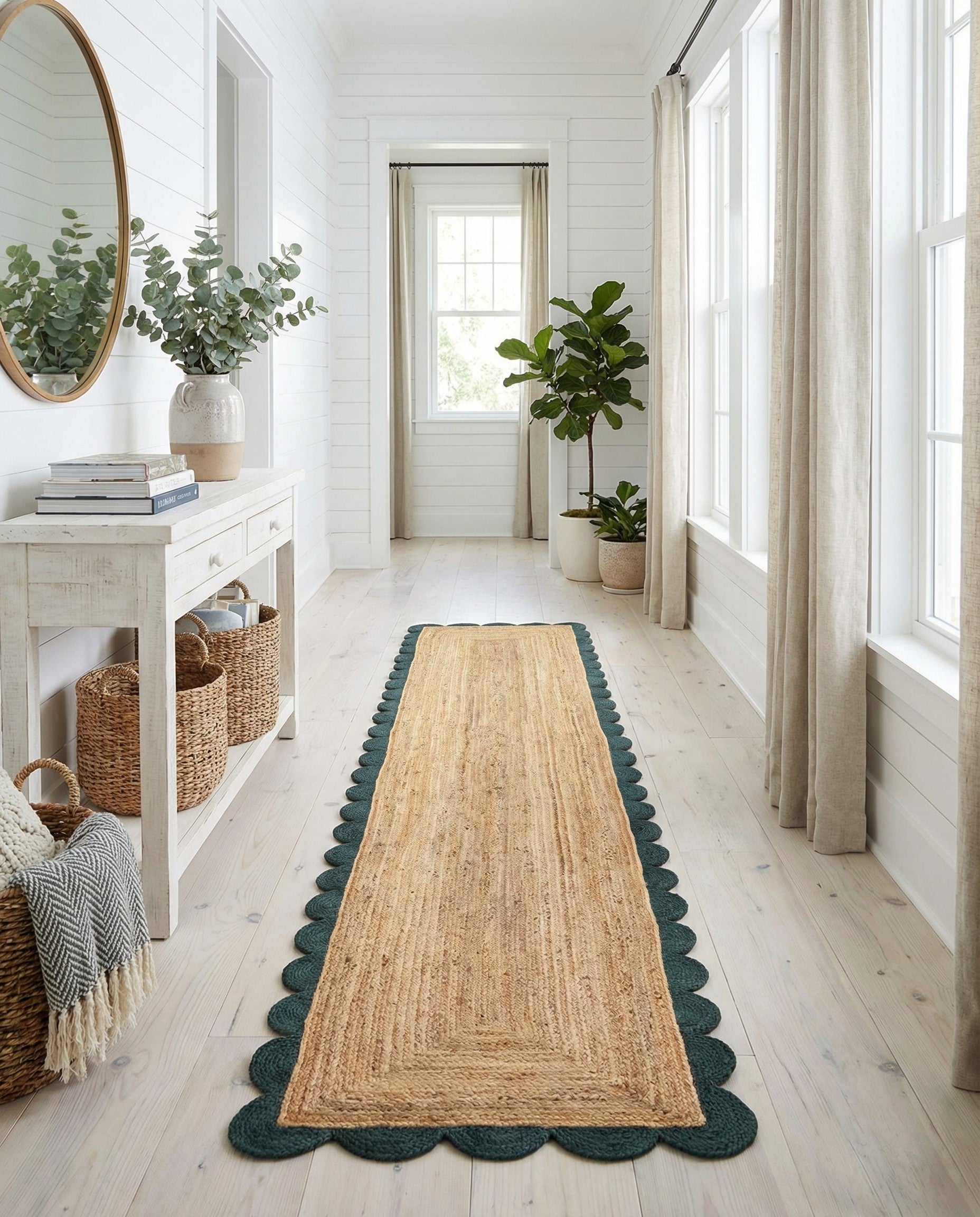 A 16 ft natural braided jute runner rug with a distinctive dark green scalloped border, perfect for a hallway.