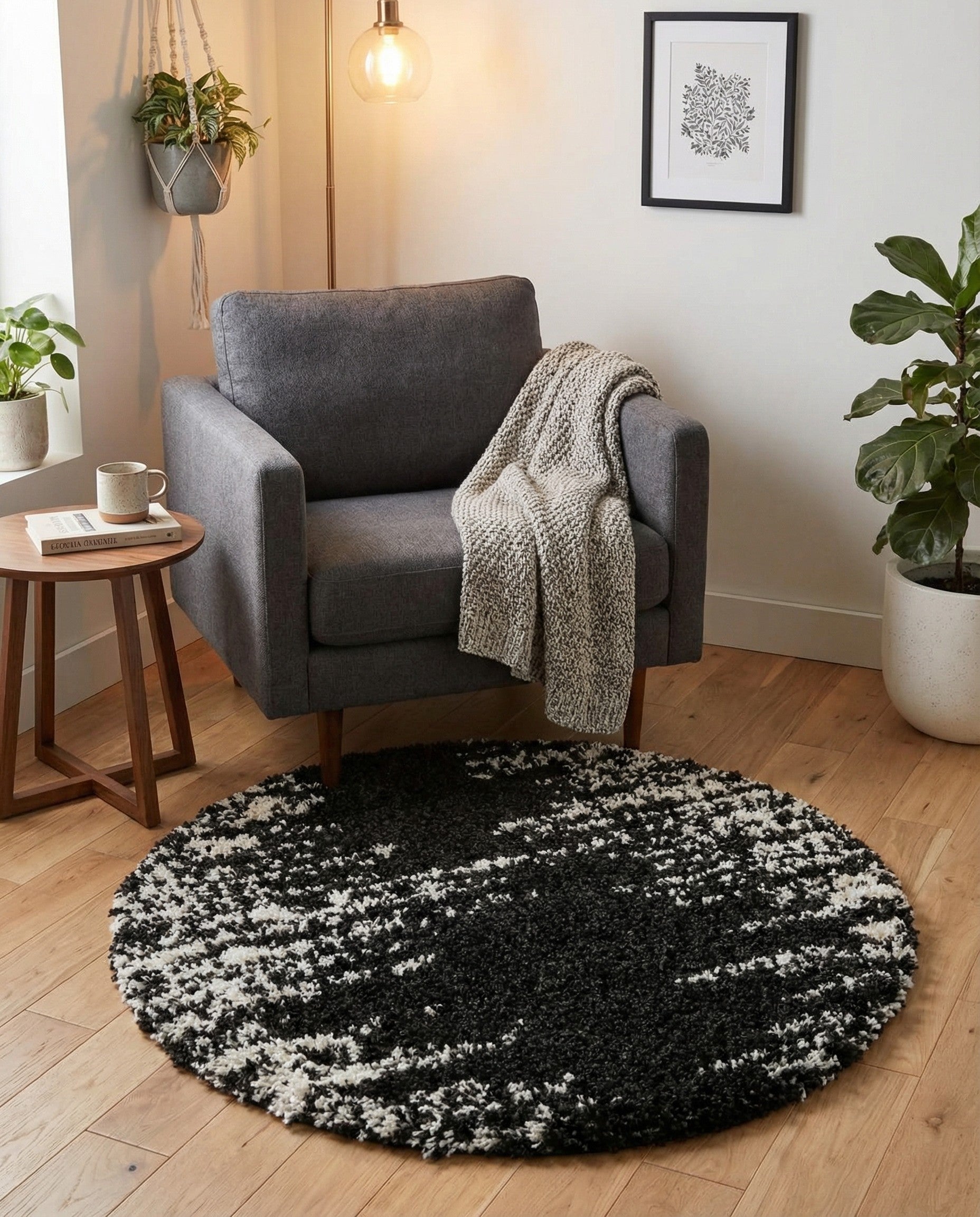 A round black and white shag rug with a speckled, abstract pattern, offering a soft, textured feel.