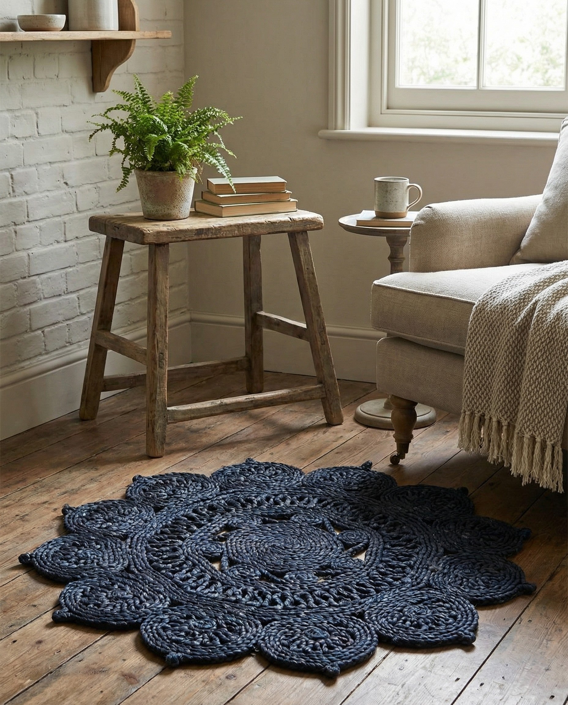A 2' 0 x 2' 0 round navy blue jute rug with a textured, braided floral-inspired pattern, ideal for indoor spaces.