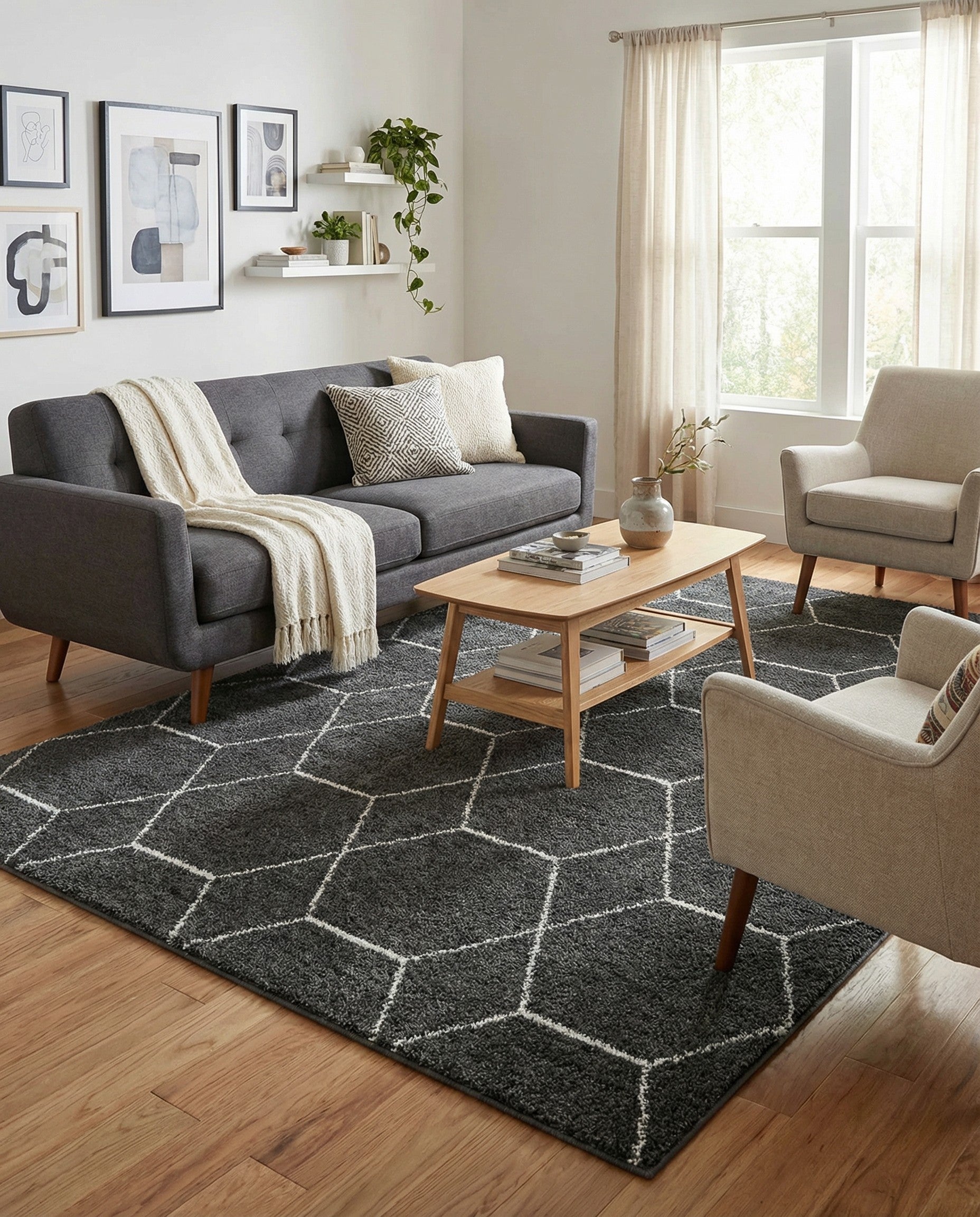 A 6x9 rectangular gray area rug featuring a modern white trellis pattern of interlocking hexagons, suitable for a living room.