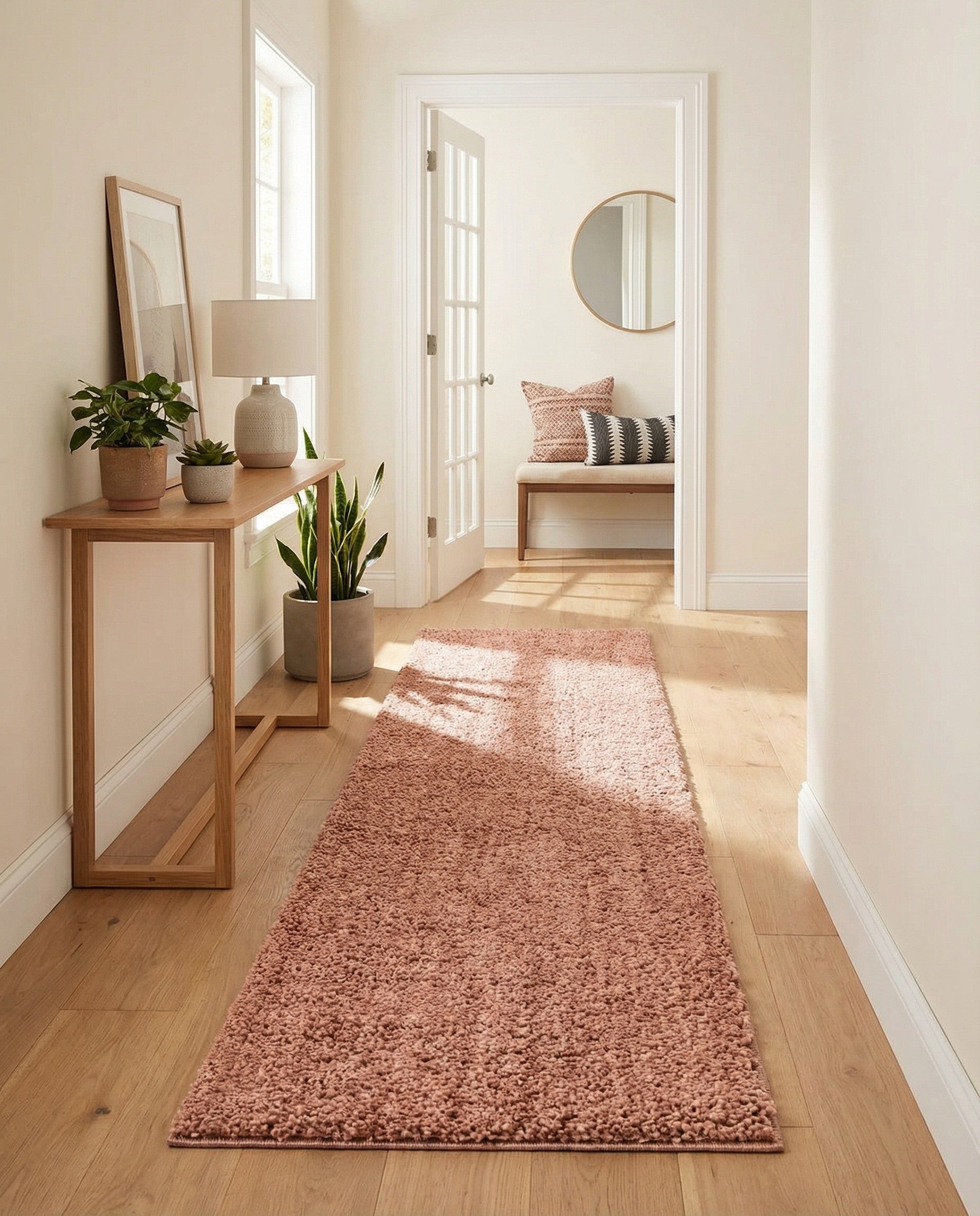 A soft, plush 8 ft runner rug in a solid pink color, featuring a shaggy texture, ideal for a hallway.