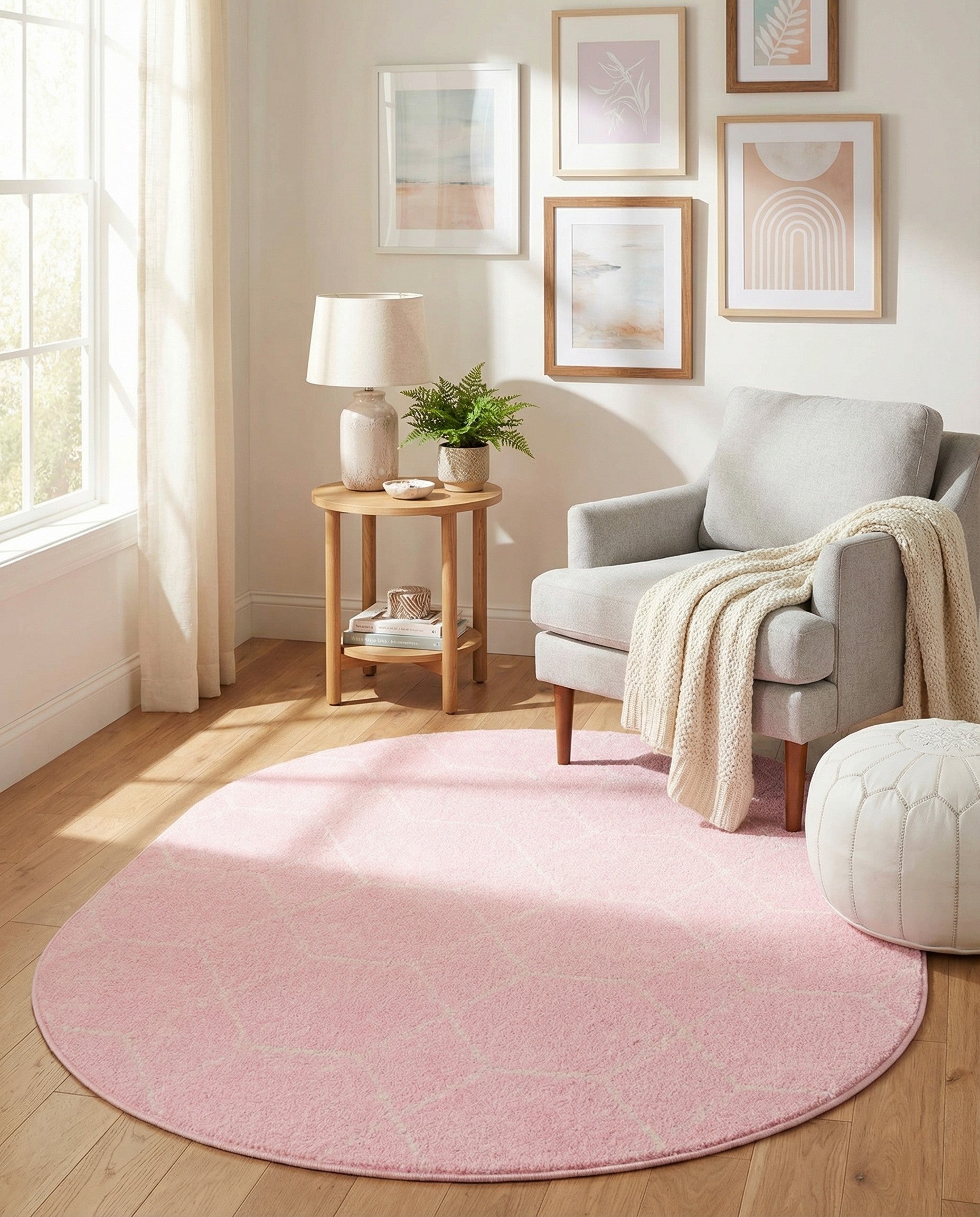 A 7' 10 x 10' 0 oval pink area rug with a subtle cream geometric trellis pattern, suitable for a modern indoor space.