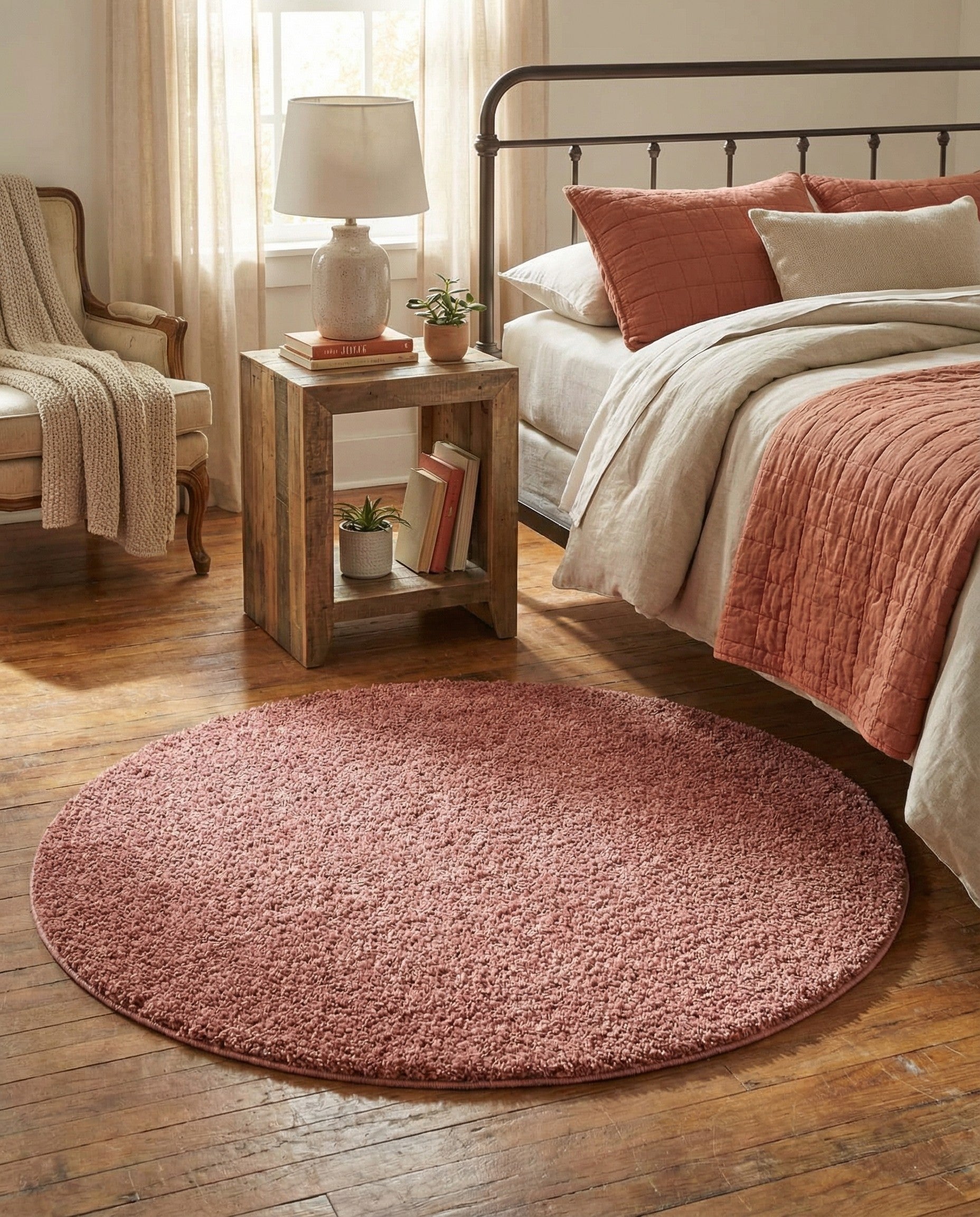 A 3' 3 x 3' 3 round shag rug in a deep red color, featuring a textured, modern solid pattern.