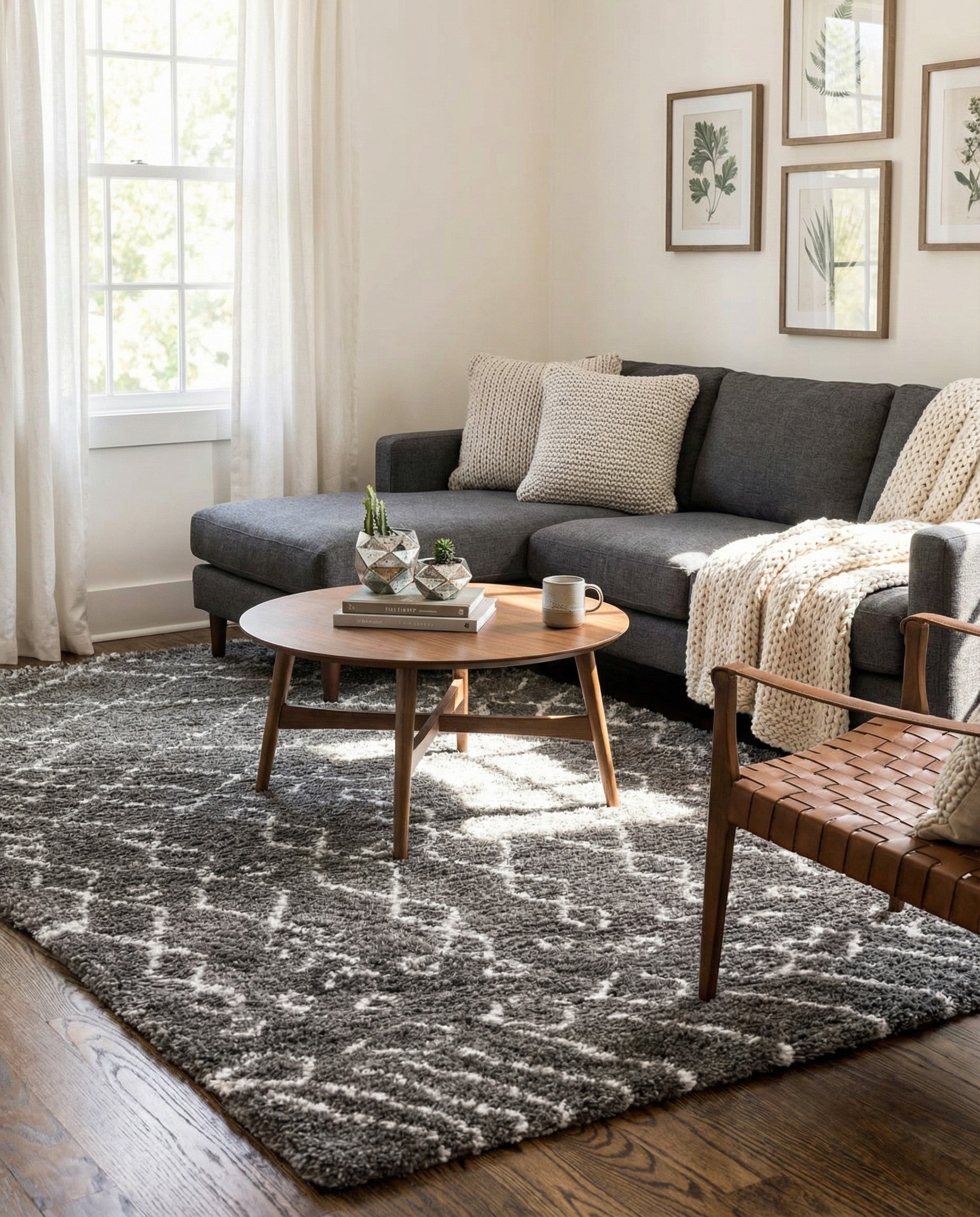 A soft 8x10 gray rectangular shag rug with a white Scandinavian tribal trellis pattern, perfect for a modern living room.
