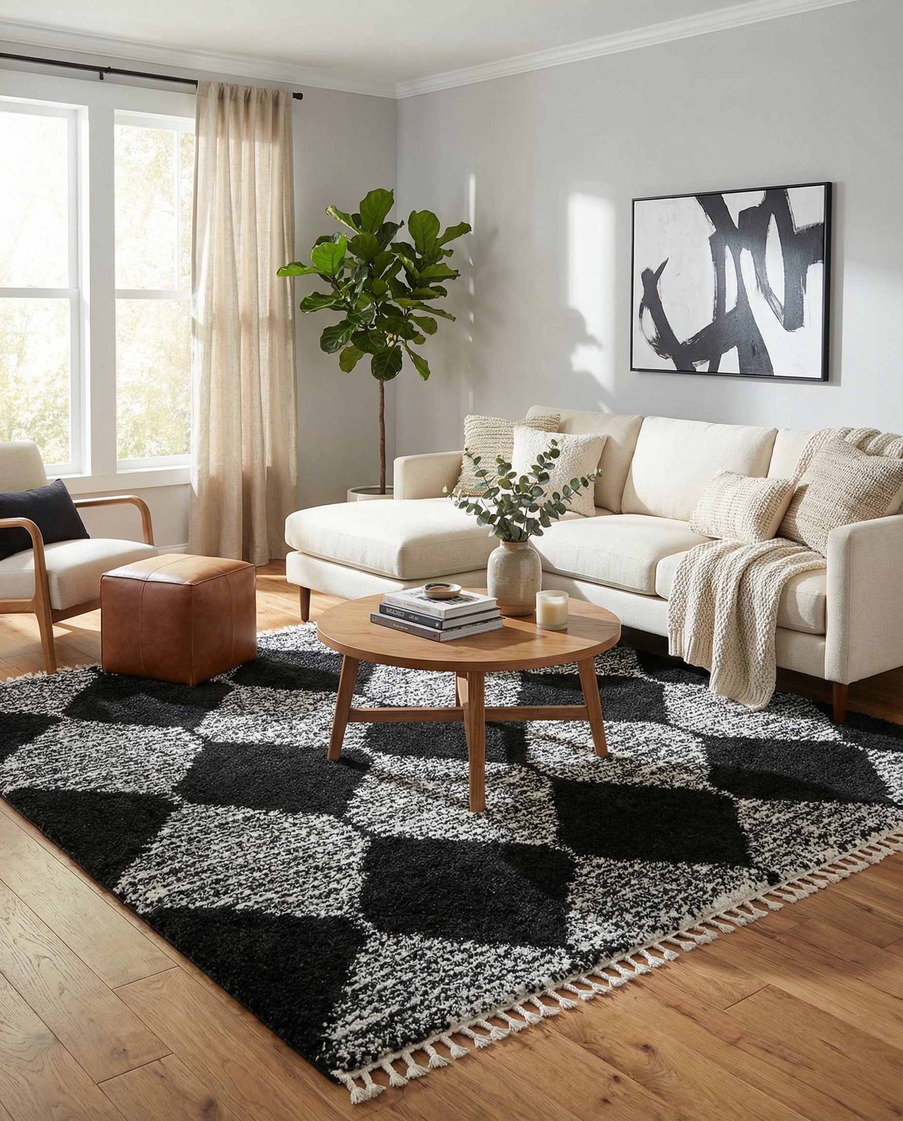A close-up of a black and white square shag rug with a modern trellis pattern, featuring large black diamond shapes against a textured ivory background, with visible fringe.