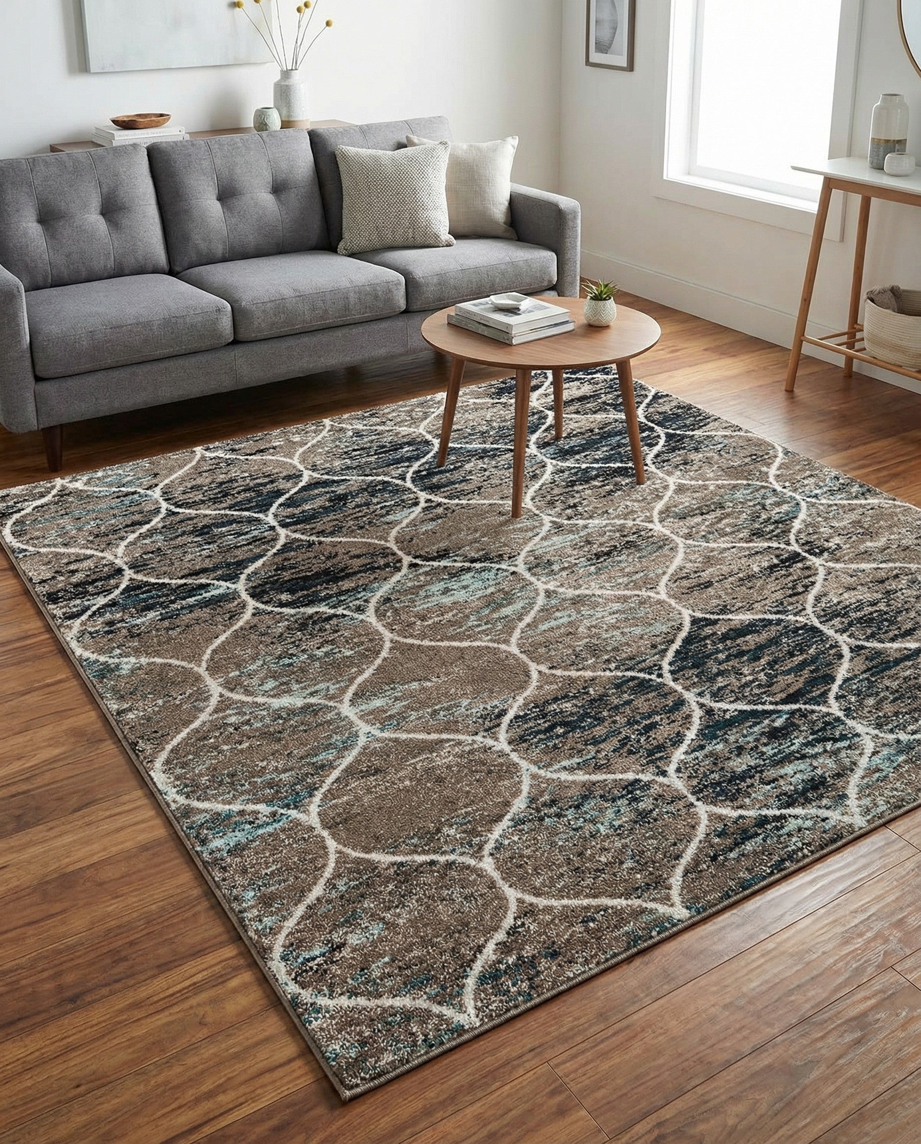 A 6x6 square modern trellis rug featuring an abstract pattern in shades of blue, brown, and black with a thin pile.