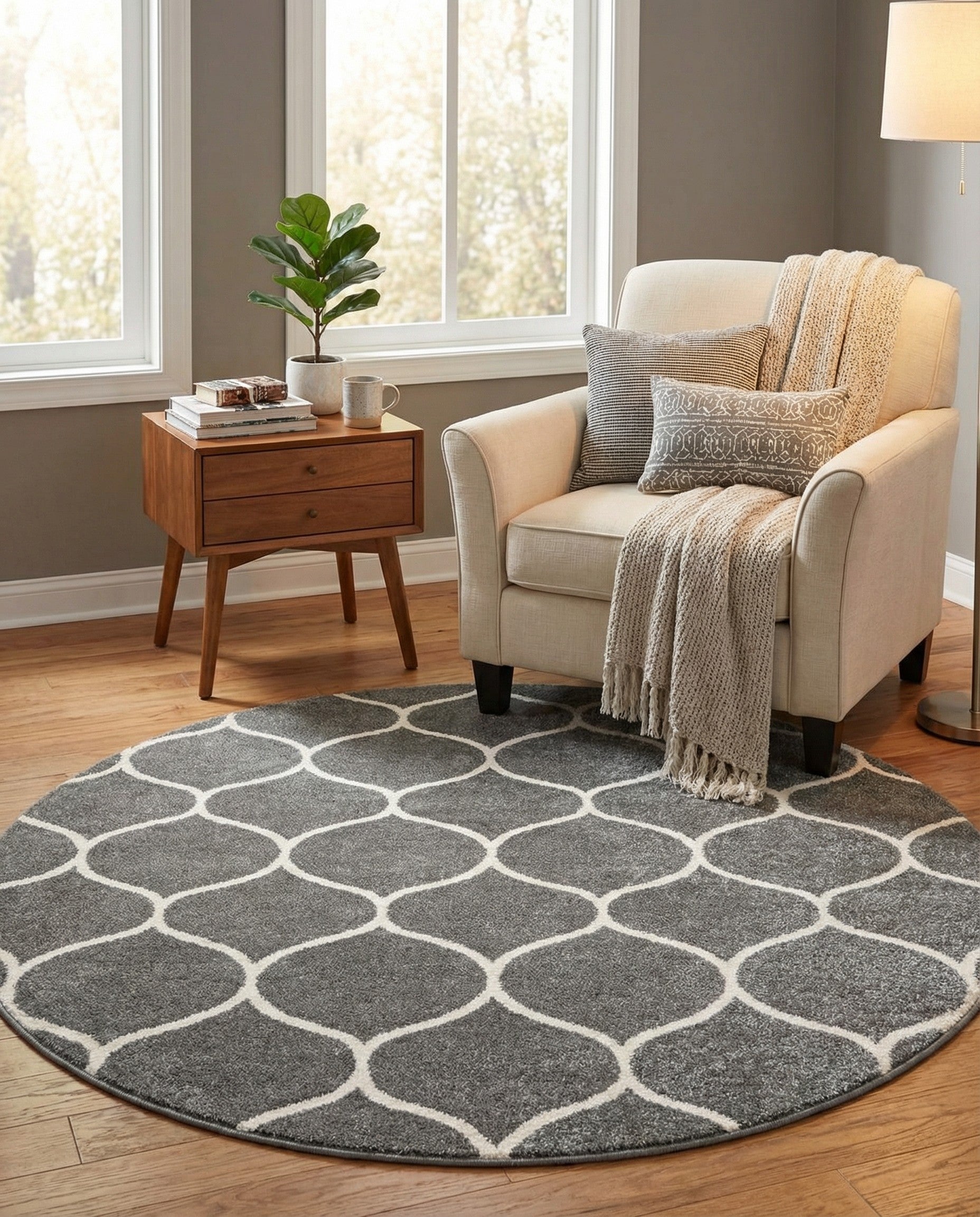 A round 7' 10 x 7' 10 gray area rug with a modern white trellis pattern, suitable for various indoor rooms.