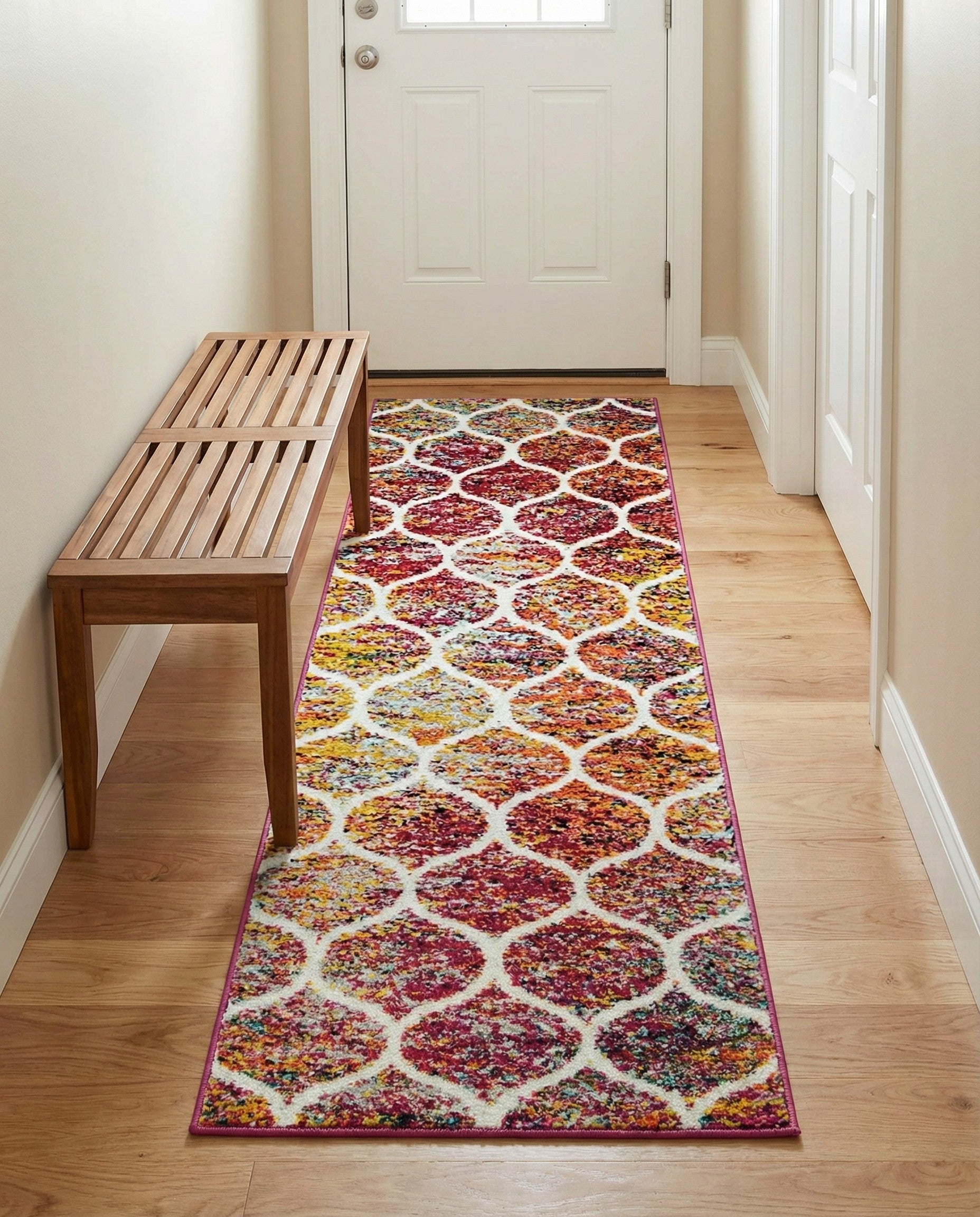 A 6 ft runner rug featuring a modern trellis pattern with multi-colored speckles of red, yellow, orange, and blue on a white background, ideal for a hallway.