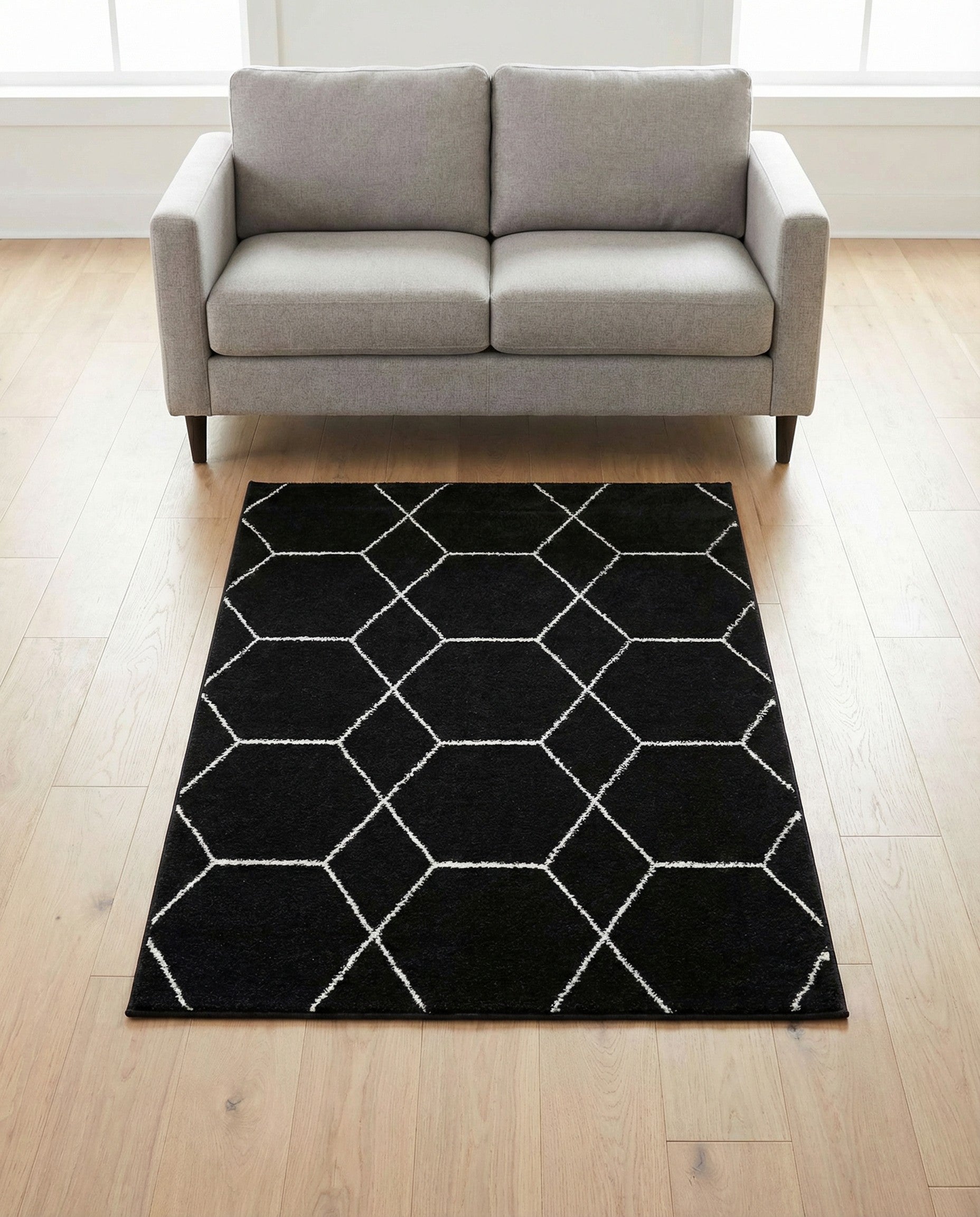 A 3x5 rectangular black rug with a white modern trellis pattern, suitable for a kitchen or entryway.